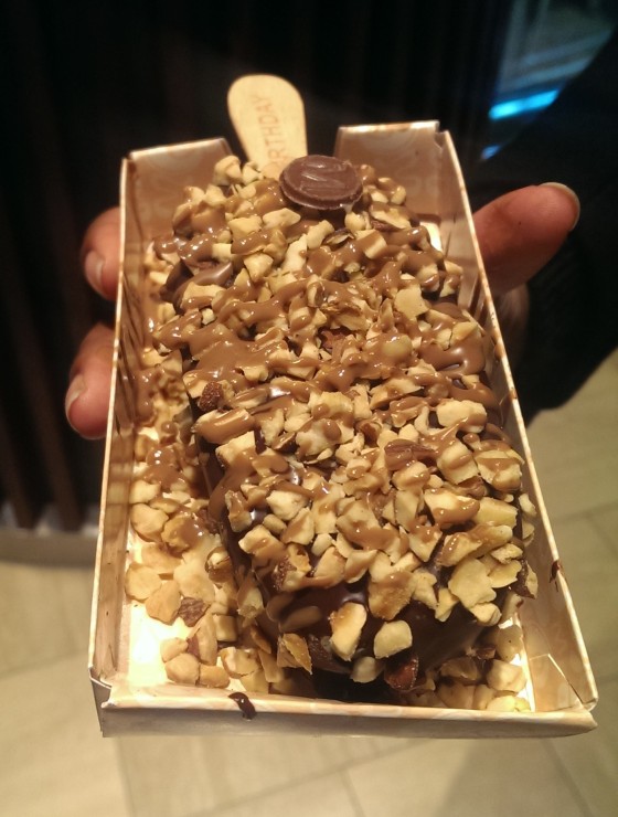 Vanilla ice cream coated in dark chocolate, sprinkled with an almonds and hazelnuts and drizzled with milk chocolate